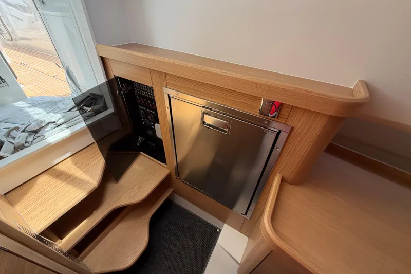Slide: The Image of Interior of 2025 Nimbus Tender 11, featuring wooden steps and stainless steel panel. - 39