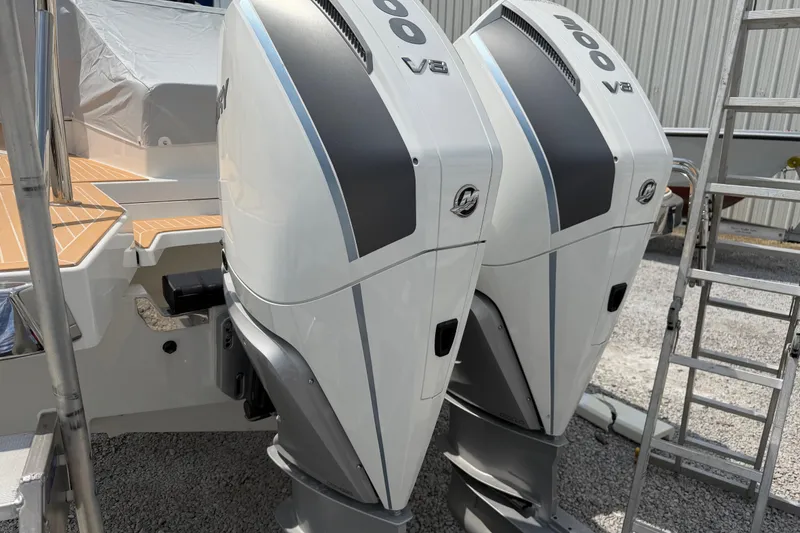 Slide: The Image of Twin V8 engines on a 2025 Nimbus Tender 11 boat, parked outdoors. - 43