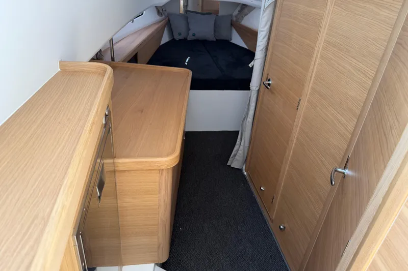 Slide: The Image of Interior of 2025 Nimbus Tender 11, featuring wooden cabinetry and a cozy sleeping area. - 6