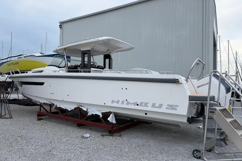 Slide: The Image of 2025 Nimbus Tender 11 boat on display in a marina setting. - 1