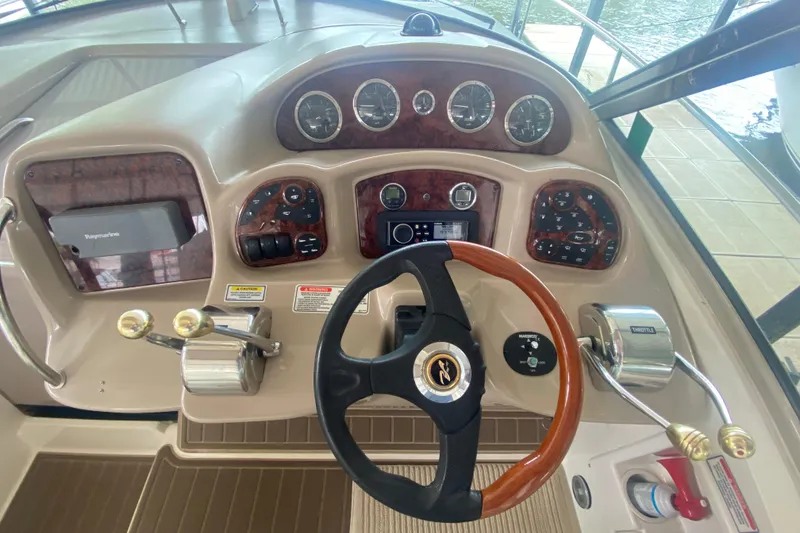 Slide: The Image of 2003 Sea Ray Sundancer 320 helm with steering wheel and control panel. - 10