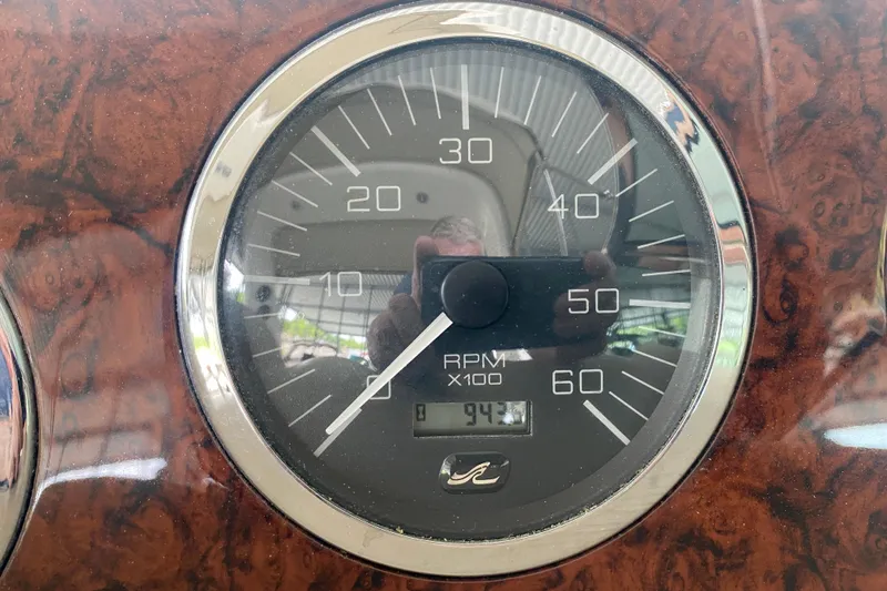 Slide: The Image of Close-up of a 2003 Sea Ray Sundancer 320 RPM gauge, showing 943 hours. - 11