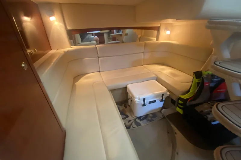 Slide: The Image of Interior of 2003 Sea Ray Sundancer 320 with beige seating and cozy lighting. - 19