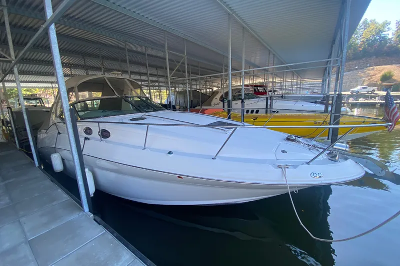 Slide: The Image of 2003 Sea Ray Sundancer 320 docked in a covered marina slip. - 38