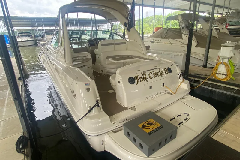 Slide: The Image of 2003 Sea Ray Sundancer 320 docked, featuring spacious deck and elegant design. - 25