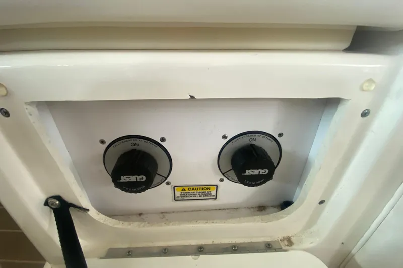 Slide: The Image of Control panel of a 2003 Sea Ray Sundancer 320 boat with dual Guest switches. - 31