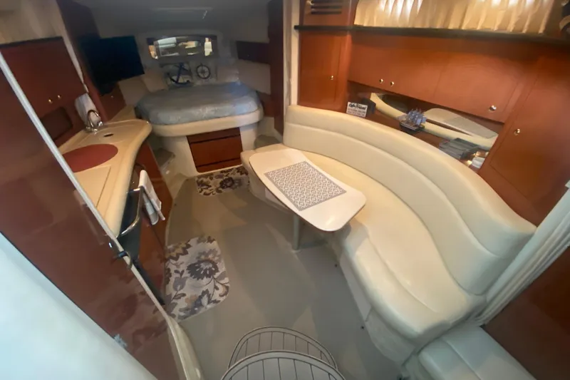 Slide: The Image of Interior of 2003 Sea Ray Sundancer 320 yacht with cozy seating and compact kitchen area. - 33