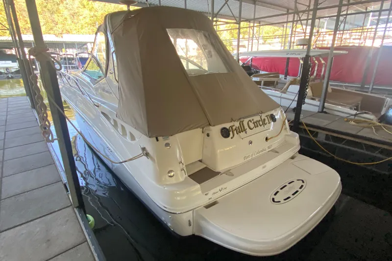 Slide: The Image of 2003 Sea Ray Sundancer 320 docked in a marina, rear view with canopy. - 41