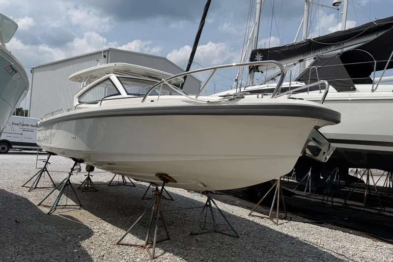 The Image of 2025 Nimbus Weekender 9 boat on stands, displayed outdoors under cloudy sky. - 0