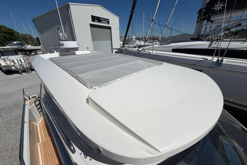 Slide: The Image of 2025 Nimbus Weekender 9 boat docked, showcasing sleek design and radar equipment. - 10