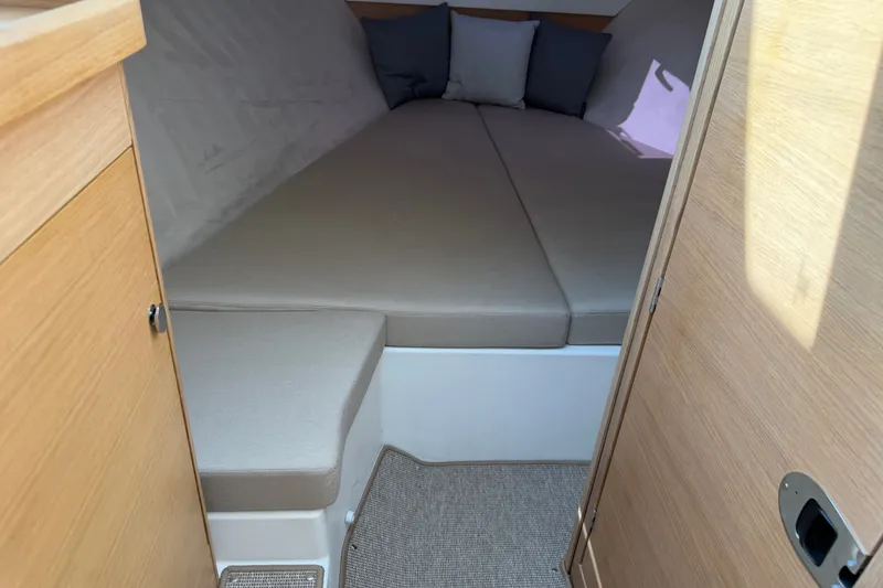 Slide: The Image of Cozy cabin interior of 2025 Nimbus Weekender 9 with comfortable bedding and cushions. - 11