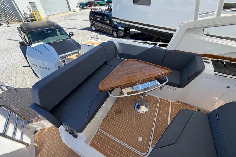 Slide: The Image of Luxurious seating area on 2025 Nimbus Weekender 9 boat with wooden table and modern design. - 4