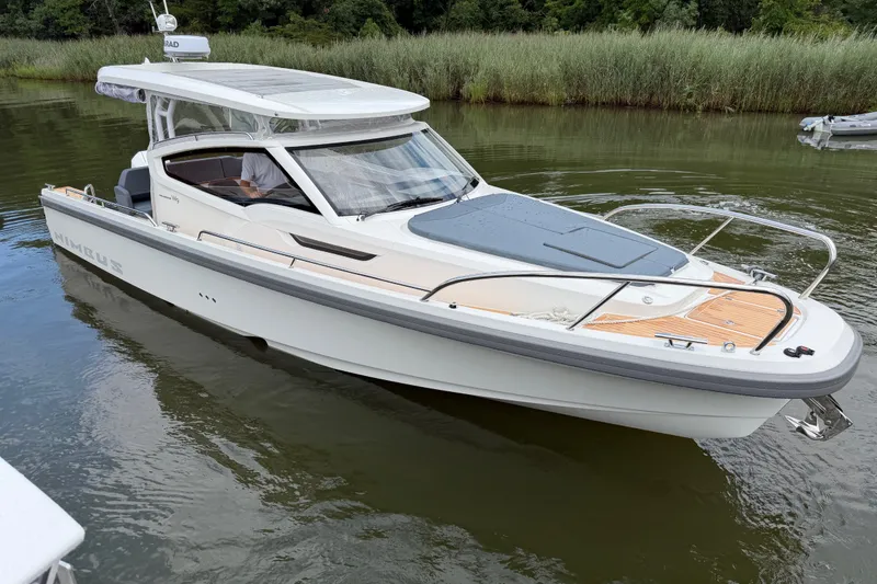 The Image of 2025 Nimbus Weekender 9 boat on calm water, featuring sleek design and modern amenities. - 0