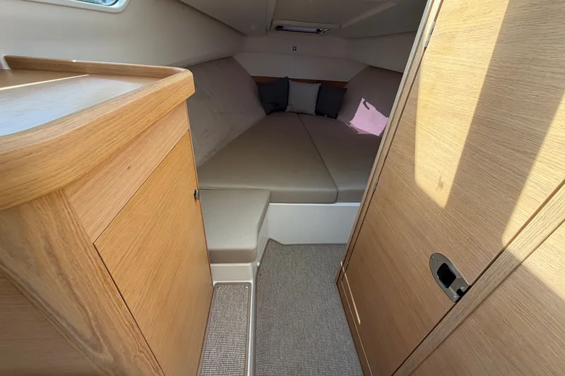 Slide: The Image of Cozy interior cabin of 2025 Nimbus Weekender 9 with wooden finish and comfortable seating. - 10