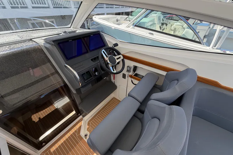 Slide: The Image of Interior cockpit of 2025 Nimbus Weekender 9 boat with modern controls and seating. - 7