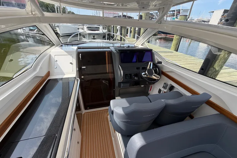 Slide: The Image of Interior of 2025 Nimbus Weekender 9 boat with modern helm and seating. - 6