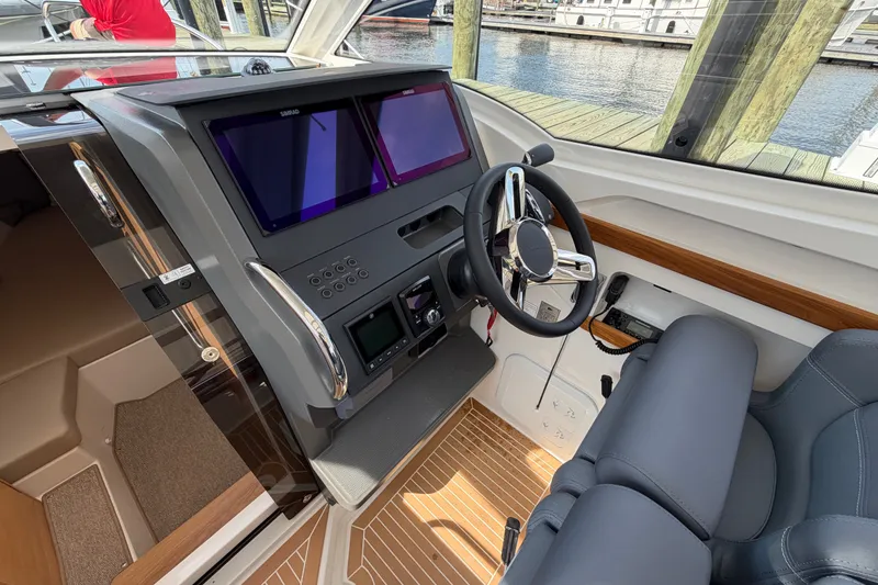 Slide: The Image of Helm of 2025 Nimbus Weekender 9 boat with modern controls and dual screens. - 9