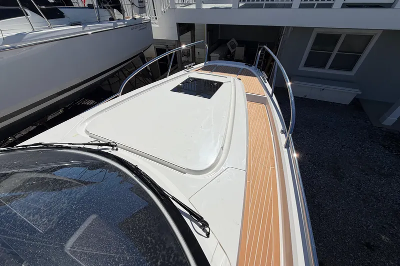 Slide: The Image of 2025 Nimbus Weekender 9 boat deck with sleek design and wooden accents. - 9