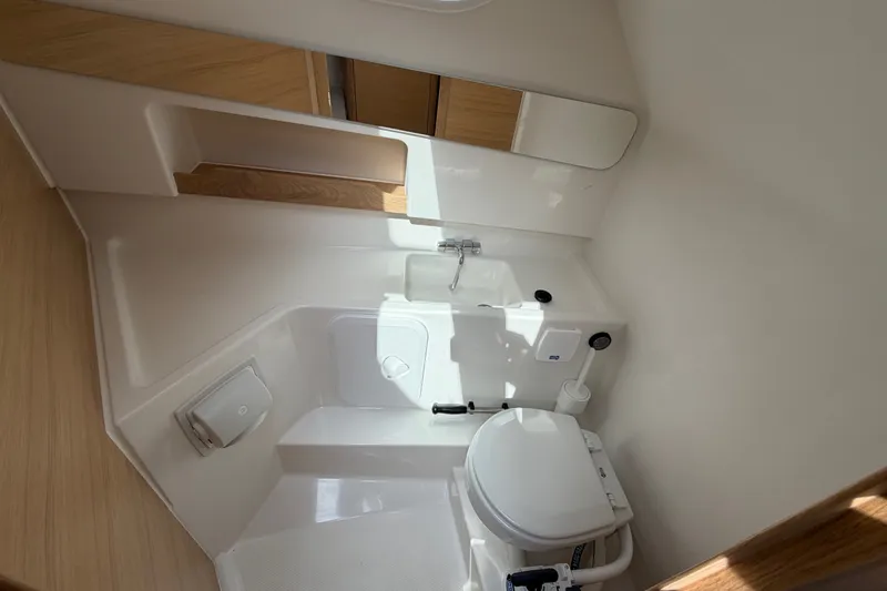 Slide: The Image of Compact bathroom in 2025 Nimbus Weekender 9 boat, featuring toilet and sink. - 12