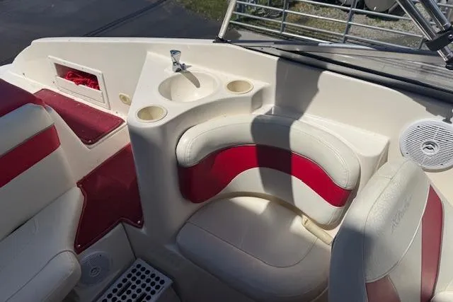 Slide: The Image of Interior of 2002 Rinker 232 Captiva Cuddy boat with red and white seating. - 14