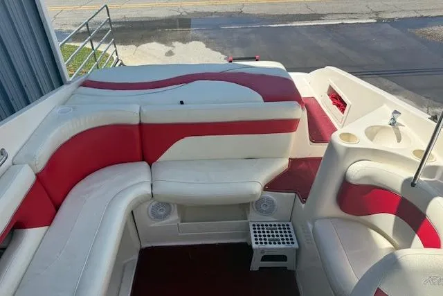 Slide: The Image of 2002 Rinker 232 Captiva Cuddy boat interior with red and white seating. - 15