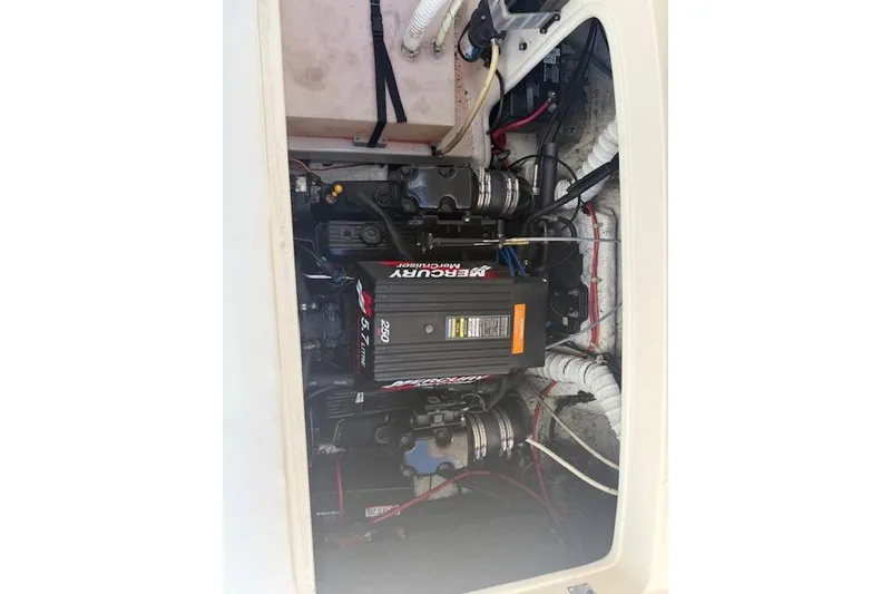 Slide: The Image of Engine compartment of a 2002 Rinker 232 Captiva Cuddy with a Mercury motor. - 16