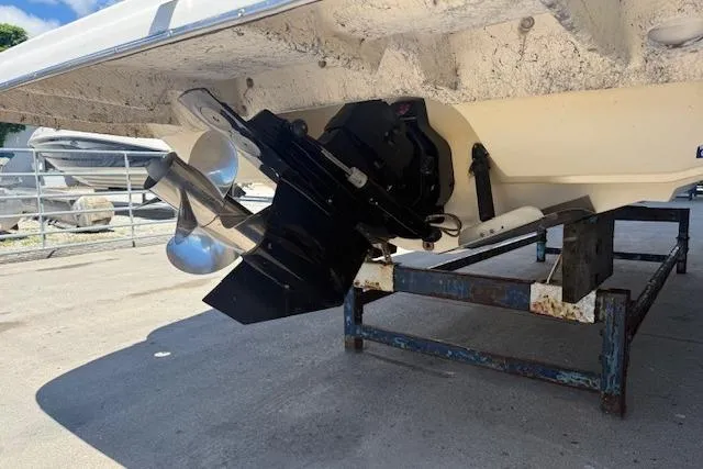 Slide: The Image of 2002 Rinker 232 Captiva Cuddy boat on stand, showing propeller and stern drive. - 17