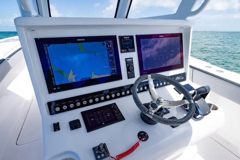 Slide: The Image of 2025 Streamline R 35 boat dashboard with advanced navigation screens and steering wheel. - 21