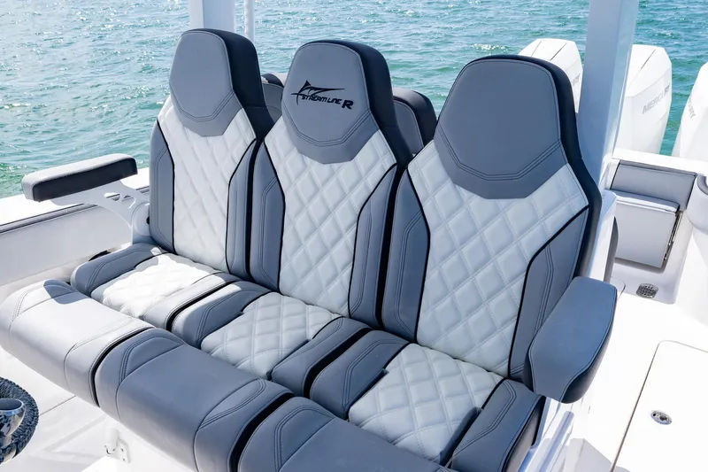 Slide: The Image of Luxurious seating on 2025 Streamline R 35 boat with quilted design, near water. - 23