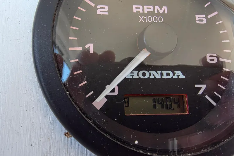Slide: The Image of Honda RPM gauge displaying 1404 hours on a 2007 custom houseboat. - 18