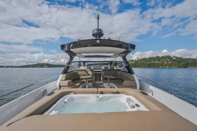 Slide: The Image of Luxurious Steeler Bronson 50 yacht with jacuzzi, cruising on a serene lake, 2022 model. - 13