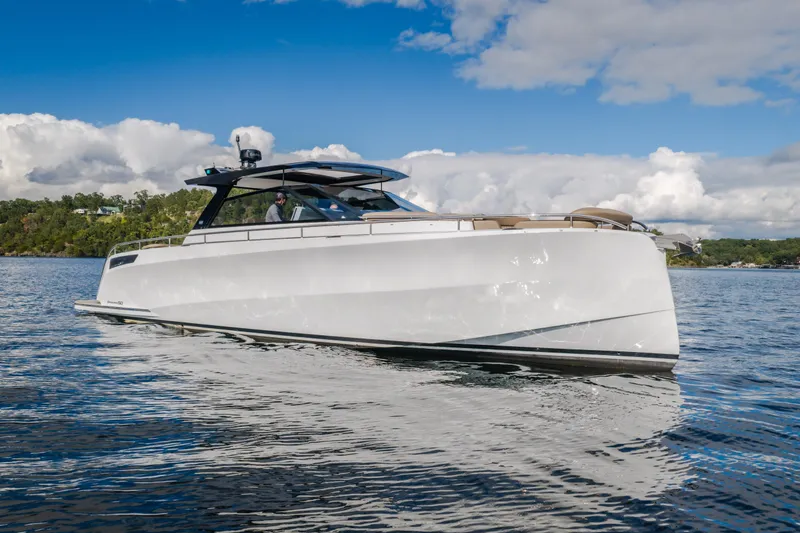 Slide: The Image of 2022 Steeler Bronson 50 yacht cruising on a serene lake under a partly cloudy sky. - 1