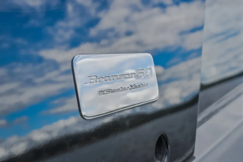 Slide: The Image of Steeler Bronson 50 yacht emblem with sky reflection, 2022 model. - 43