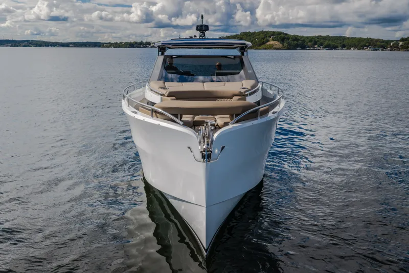 Slide: The Image of 2022 Steeler Bronson 50 yacht cruising on a calm lake under a cloudy sky. - 6