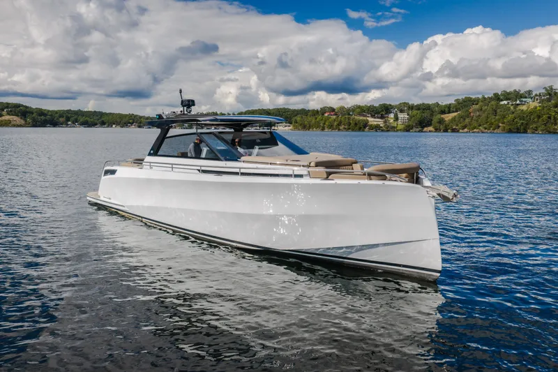 Slide: The Image of 2022 Steeler Bronson 50 yacht cruising on a scenic lake under a cloudy sky. - 9