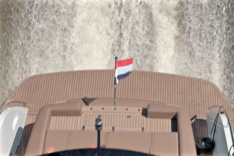 Slide: The Image of Steeler Bronzon 50 yacht cruising, rear view with flag, 2022 model. - 4