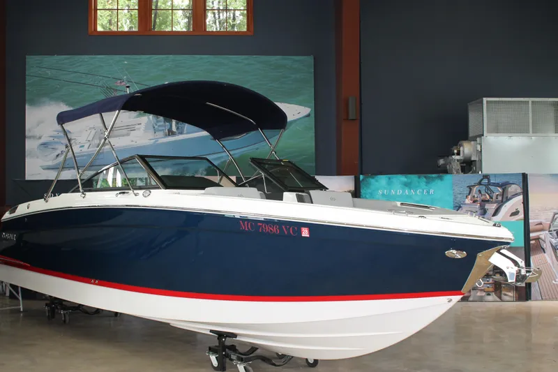 The Image of 2023 Cobalt R8 boat with blue hull and canopy displayed indoors. - 0