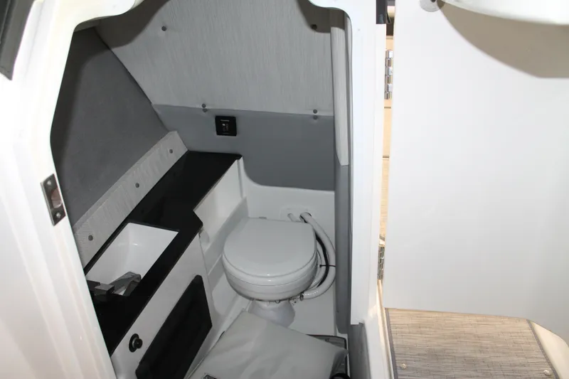 Slide: The Image of 2023 Cobalt R8 boat interior bathroom with modern design and compact toilet. - 17