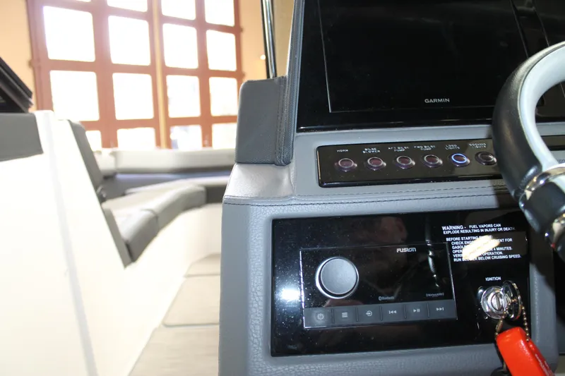 Slide: The Image of Interior view of a 2023 Cobalt R8 boat dashboard with steering wheel and controls. - 23