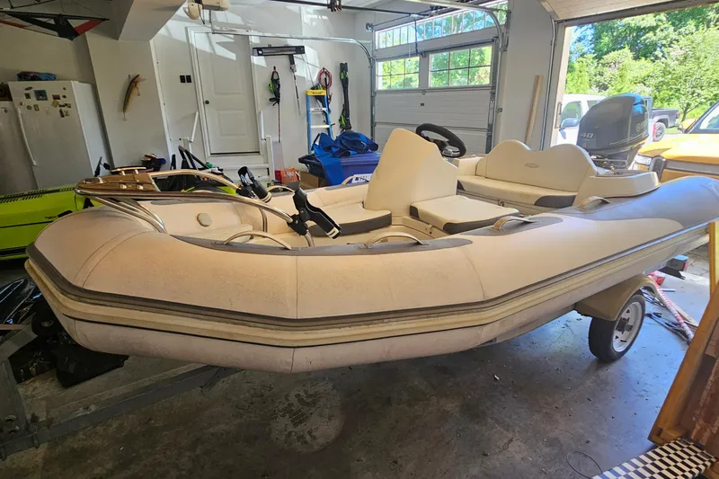The Image of 2014 Zodiac Yachtline 2 Deluxe 380 inflatable boat in a garage setting. - 1