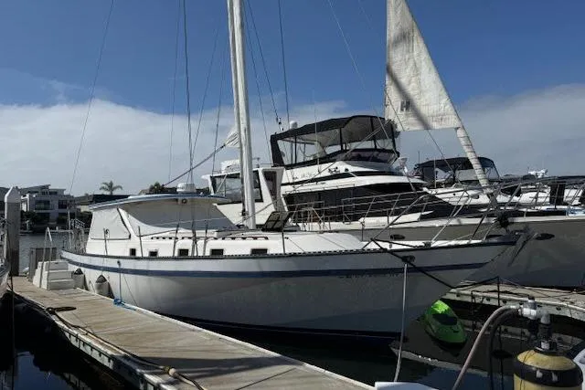 The Image of 1982 Lancer 45 Motorsailer docked at marina under clear blue sky. - 1