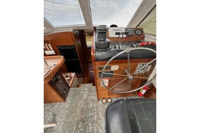 Slide: The Image of Interior view of 1982 Lancer 45 Motorsailer cockpit with steering wheel and navigation equipment. - 12