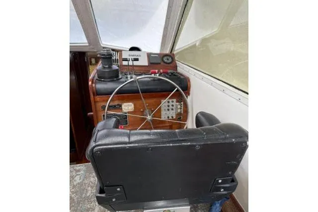 Slide: The Image of 1982 Lancer 45 Motorsailer helm with steering wheel and navigation equipment. - 14