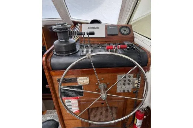 Slide: The Image of Helm of 1982 Lancer 45 Motorsailer with steering wheel and navigation controls. - 15