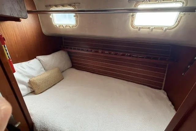 Slide: The Image of Cozy cabin interior of 1982 Lancer 45 Motorsailer with wooden accents and bedding. - 17