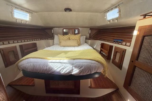 Slide: The Image of Cozy cabin interior of 1982 Lancer 45 Motorsailer with bed and wooden accents. - 19
