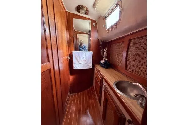 Slide: The Image of 1982 Lancer 45 Motorsailer bathroom with wooden interior and sink. - 25