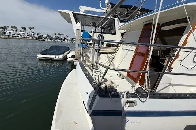 Slide: The Image of 1982 Lancer 45 Motorsailer docked in a marina with nearby boats. - 30