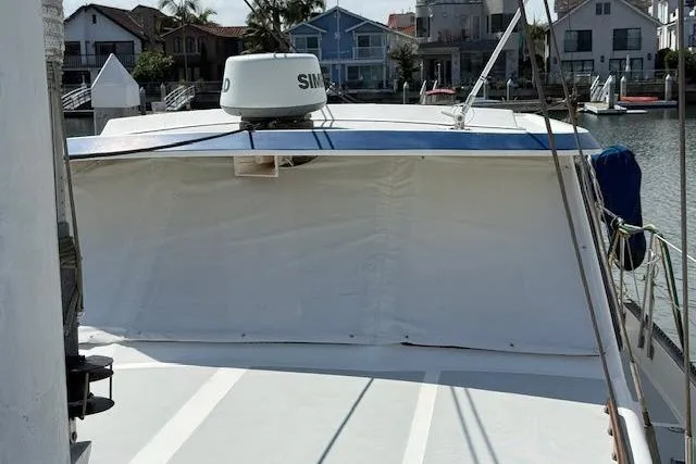 Slide: The Image of 1982 Lancer 45 Motorsailer docked, featuring a covered deck and radar equipment. - 32