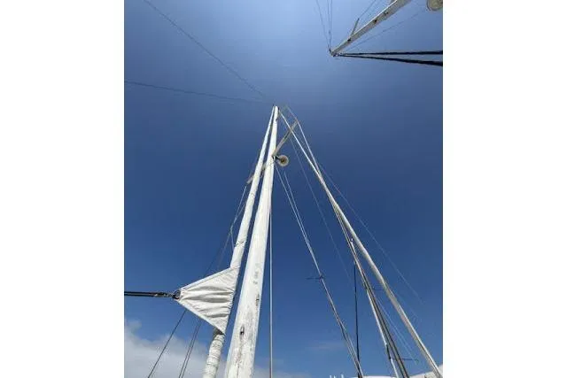 Slide: The Image of Masts of 1982 Lancer 45 Motorsailer against clear blue sky. - 36